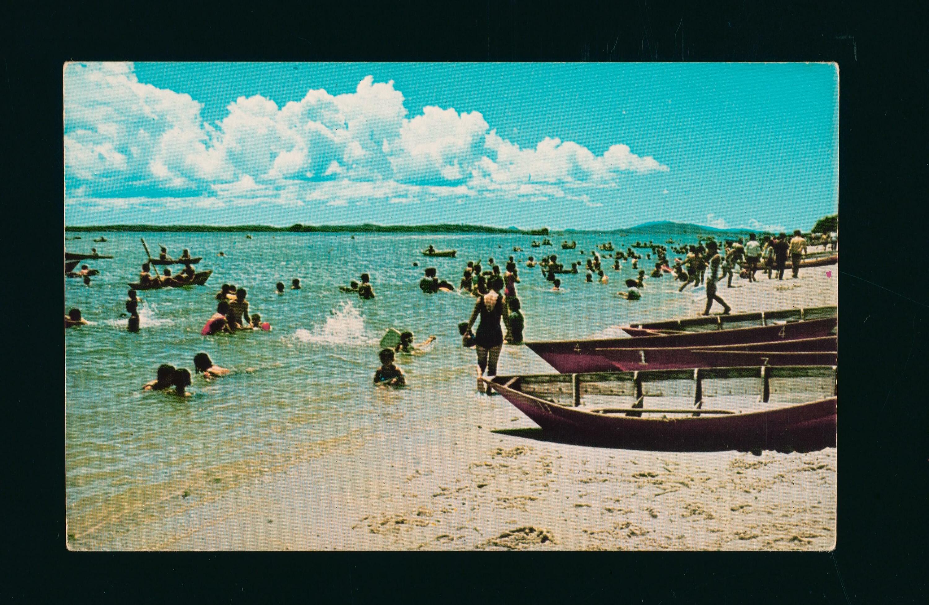 Day-trippers at Changi Beach, swimming and rowing boats in the ocean, c. 1970s
