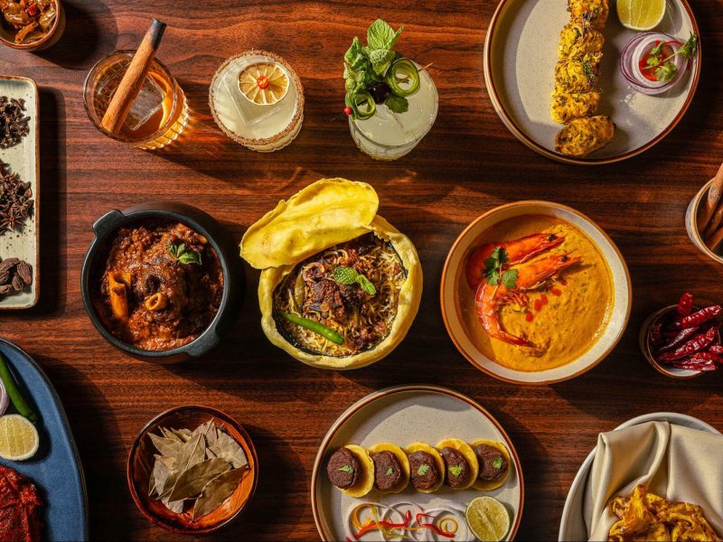 Different Indian dishes laid on a table